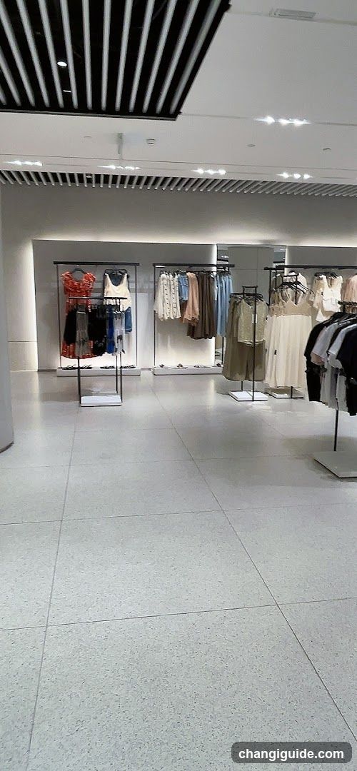 Interior of a retail store with perfume display and clothing racks