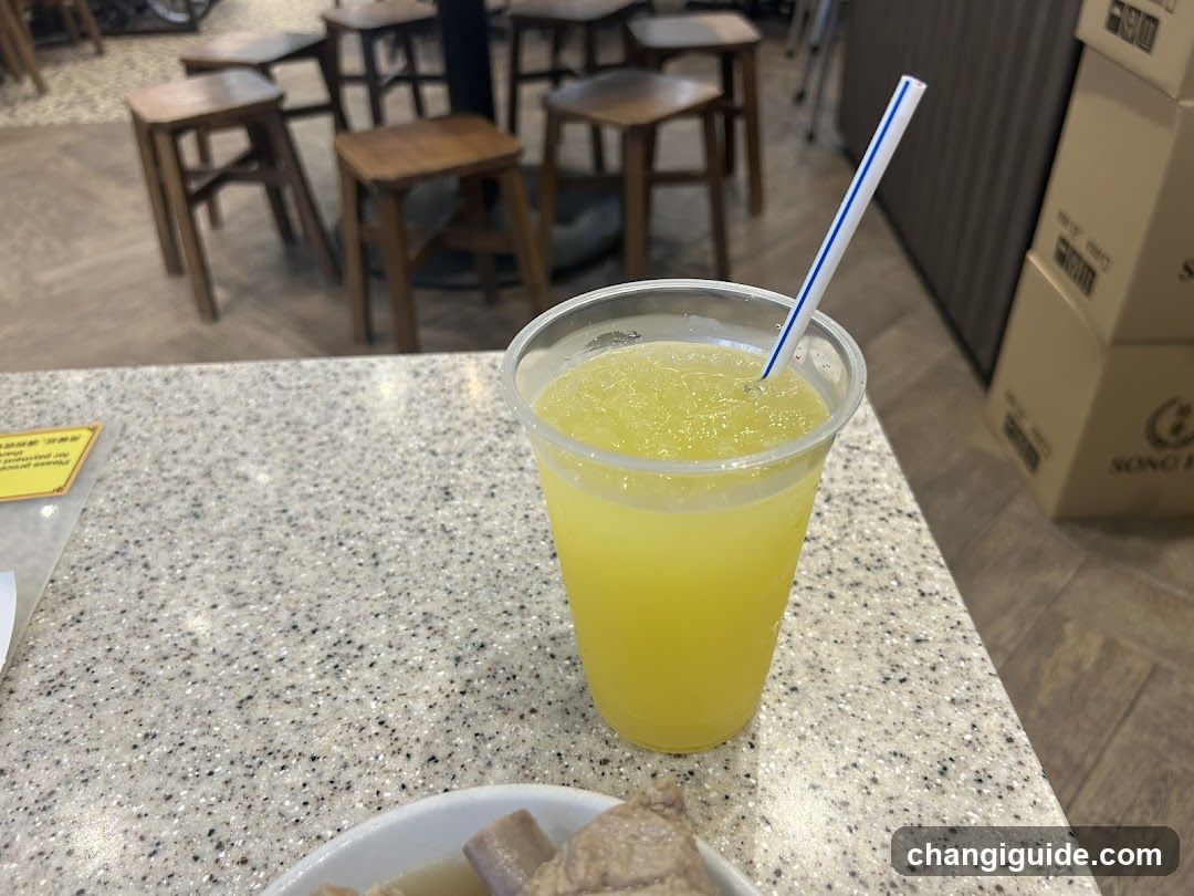 Yellow Drink with Straw on Speckled Counter