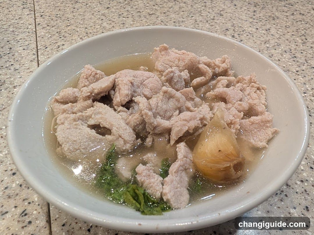 Bowl of Meat Soup with Garlic and Greens