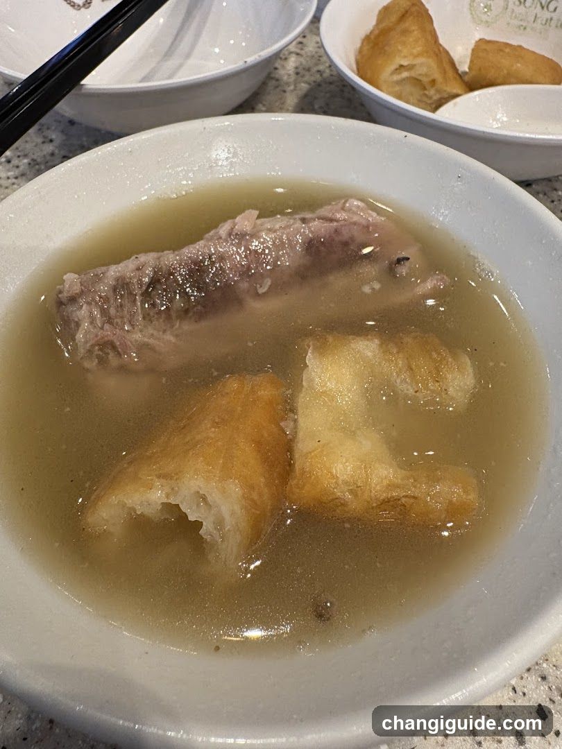 Bowl of Soup with Meat and Fried Dough