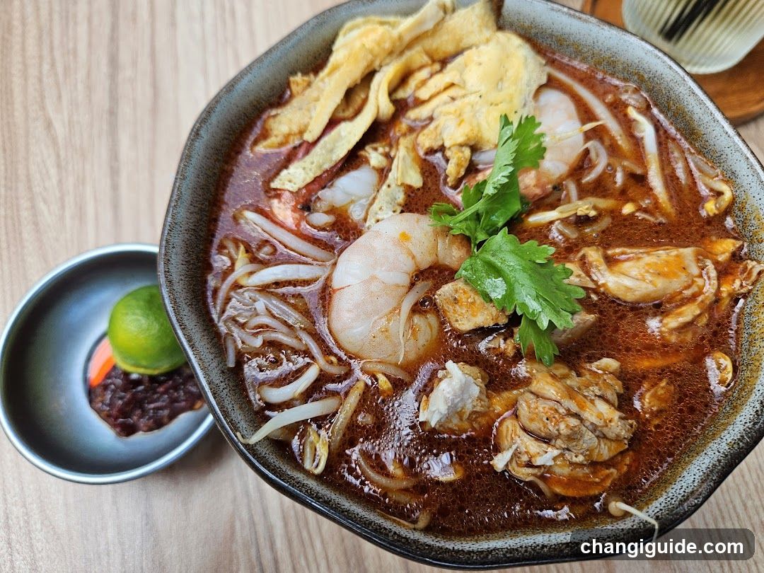 Bowl of Spicy Noodle Soup with Shrimp and Chicken