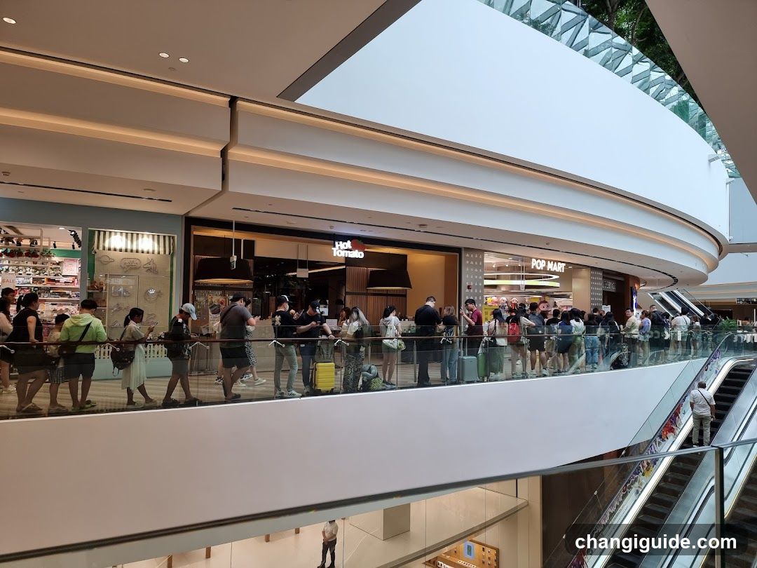 Crowded Mall Corridor with Storefronts