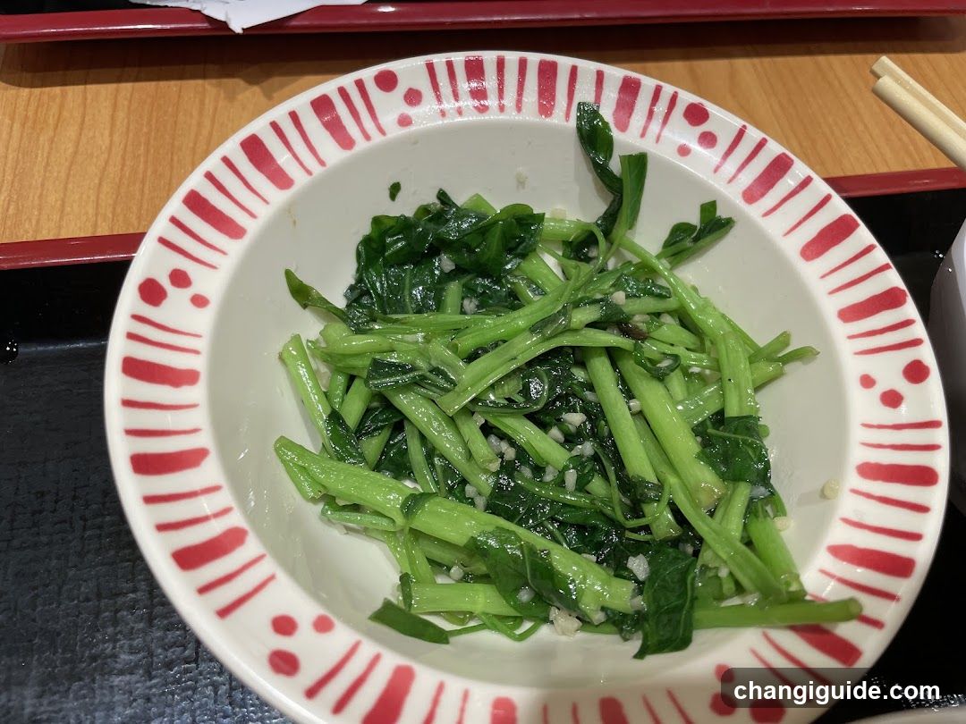 Bowl of stir-fried greens with garlic