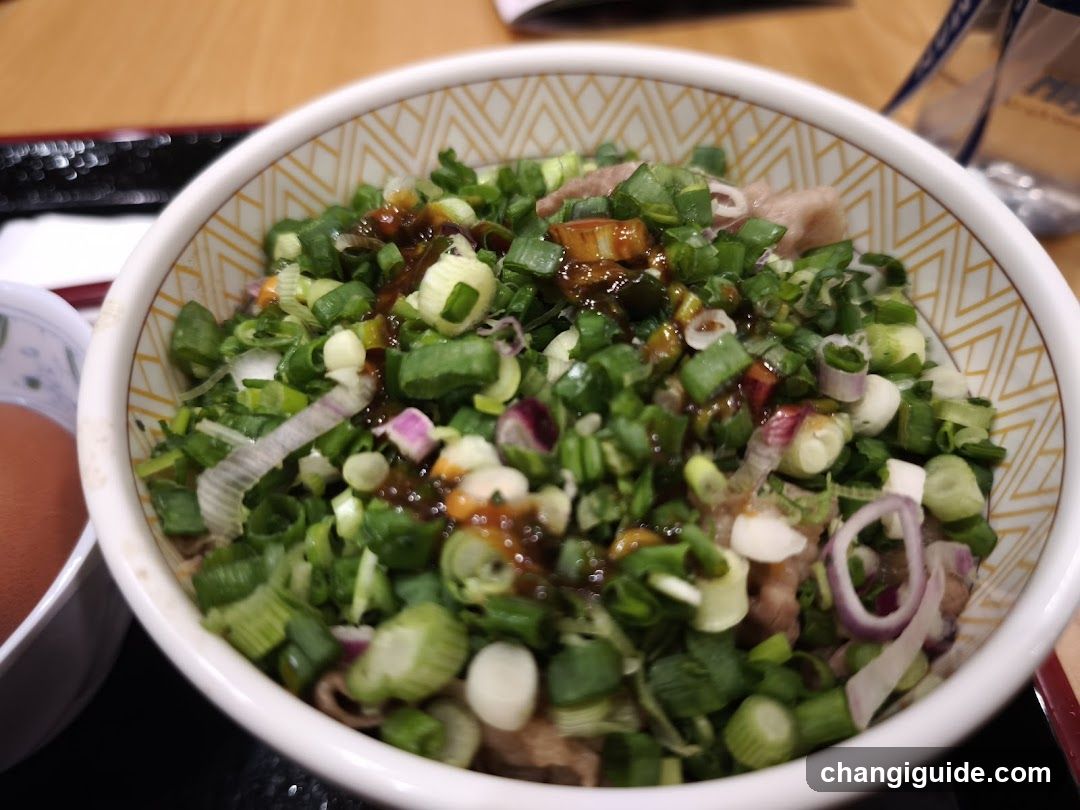 Bowl of Green Onion Topped Dish