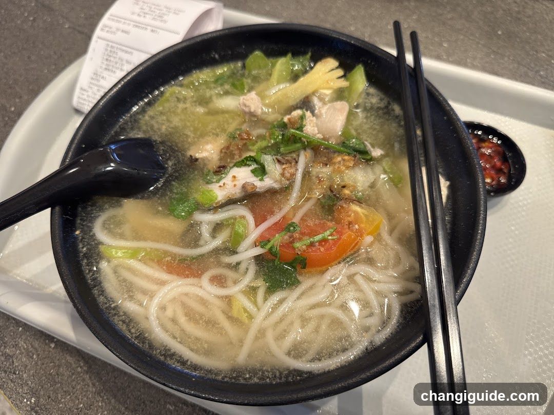 Bowl of Noodle Soup with Chopsticks and Spoon