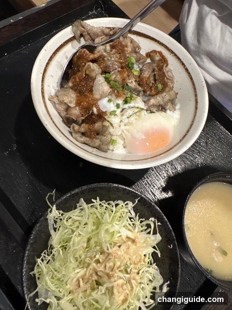 Bowl of Beef Rice with Egg and Side Dishes