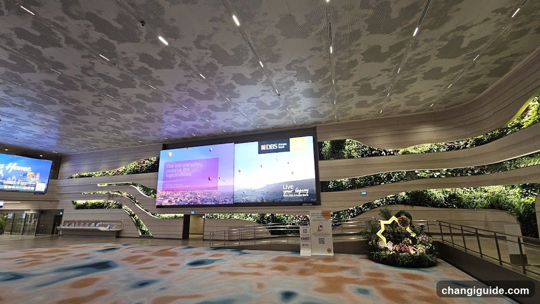 Indoor Public Space with Digital Screens and Greenery