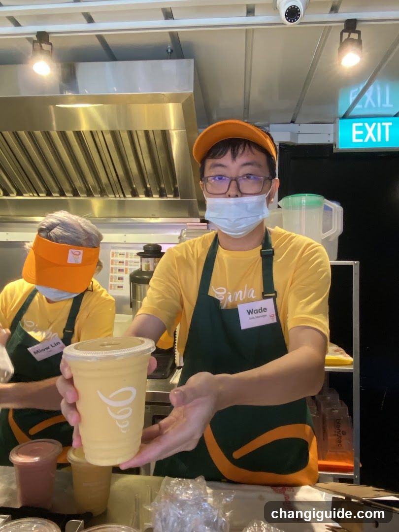 Staff serving a drink at a food stall