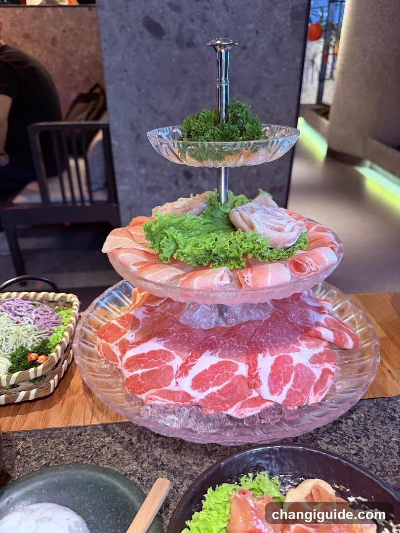 Three-tiered meat platter with ice and garnish
