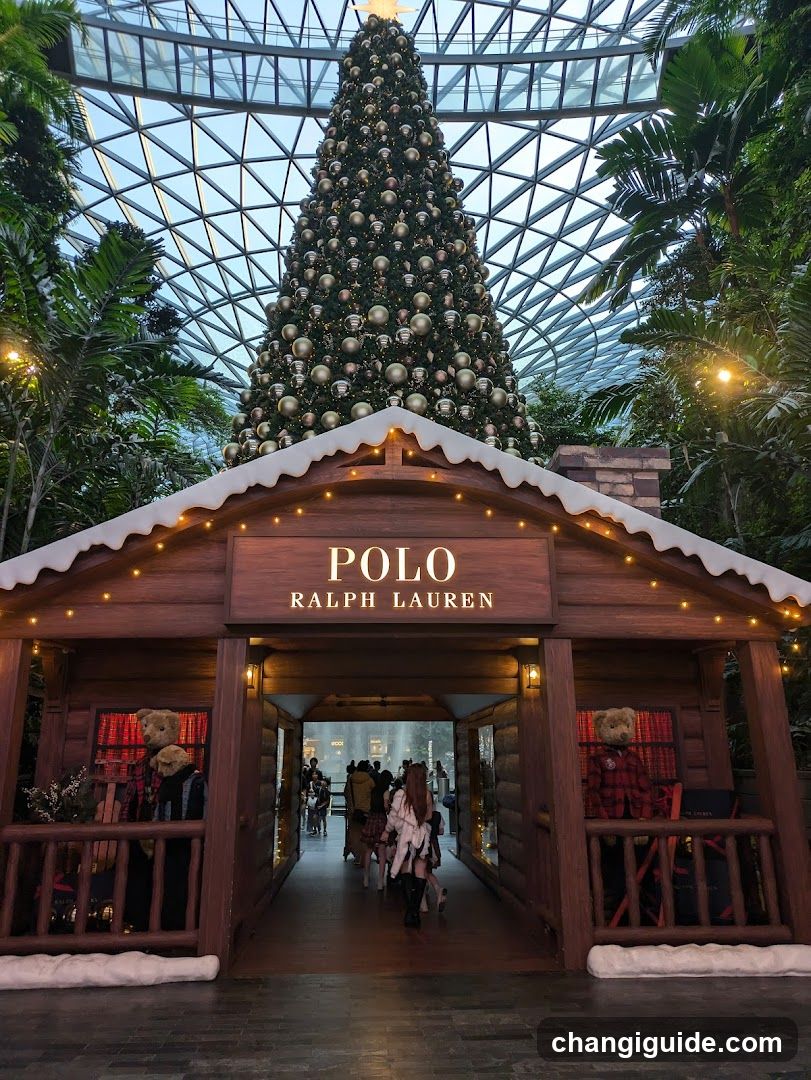 A festive wooden storefront with a sign reading 'POLO RALPH LAUREN' above the entrance, decorated with string lights and artificial snow on the roof. A large Christmas tree is visible in the background under a glass dome ceiling.