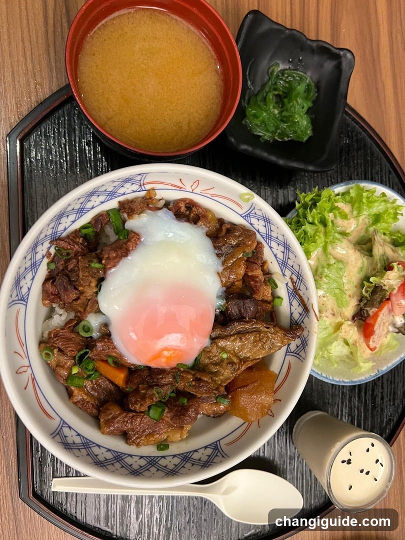 Japanese-style meal set with rice bowl, soup, and salad