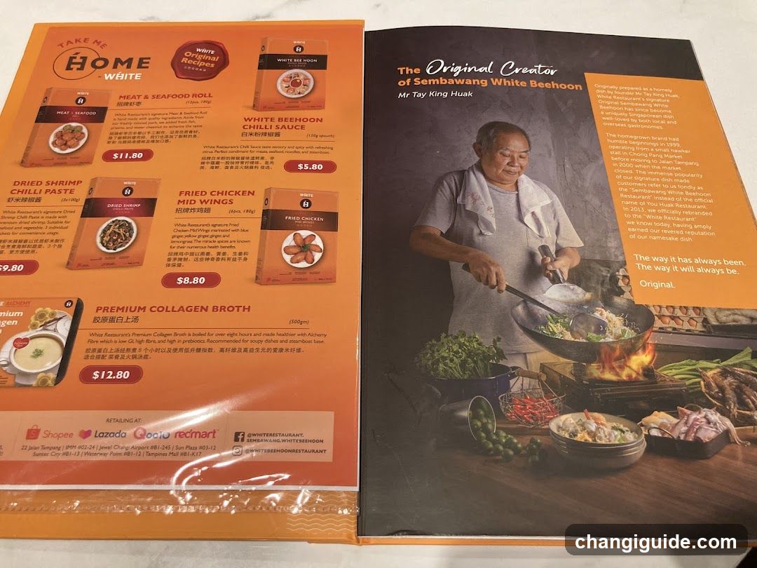 A printed menu featuring dishes like Meat & Seafood Roll, White Beehoon Chili Sauce, Dried Shrimp Chili Paste, Fried Chicken Mid Wings, Premium Collagen Broth, and White Beehoon. The right page highlights the restaurant's history with Mr Tay King Huak and includes a photo of him cooking.