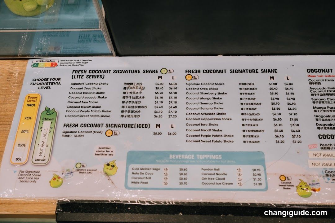 A printed menu board featuring a variety of coconut-based shakes and signature drinks, with prices in USD and Chinese characters.