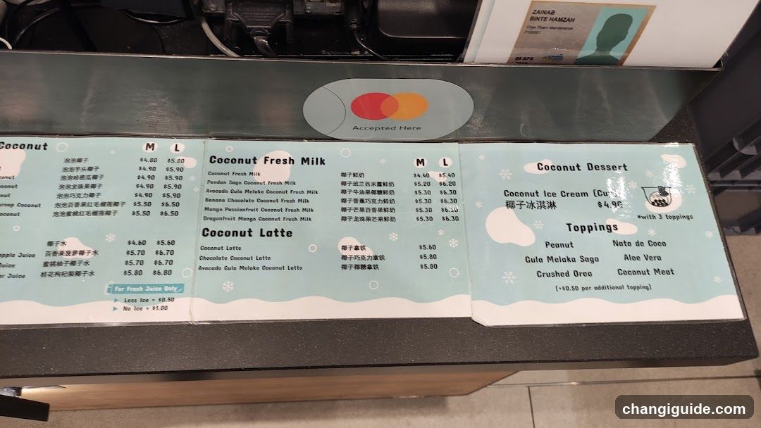 A close-up of a menu board featuring coconut-themed drinks and desserts, with prices in M and L sizes.
