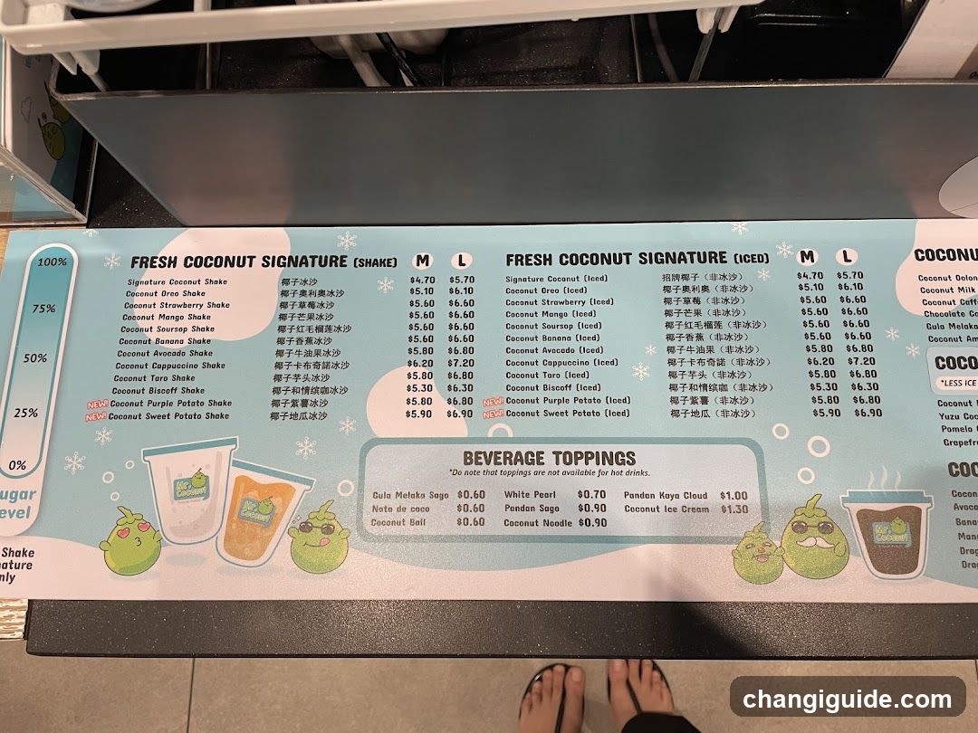 A menu board displaying fresh coconut signature shakes and frozen drinks with prices in Thai Baht, alongside beverage toppings like milk, pearls, and ice cream.