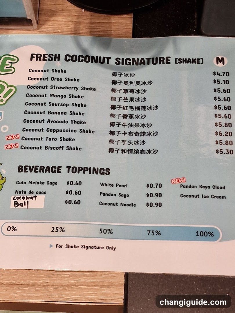 A menu board displaying coconut-themed shakes and toppings with prices in USD.