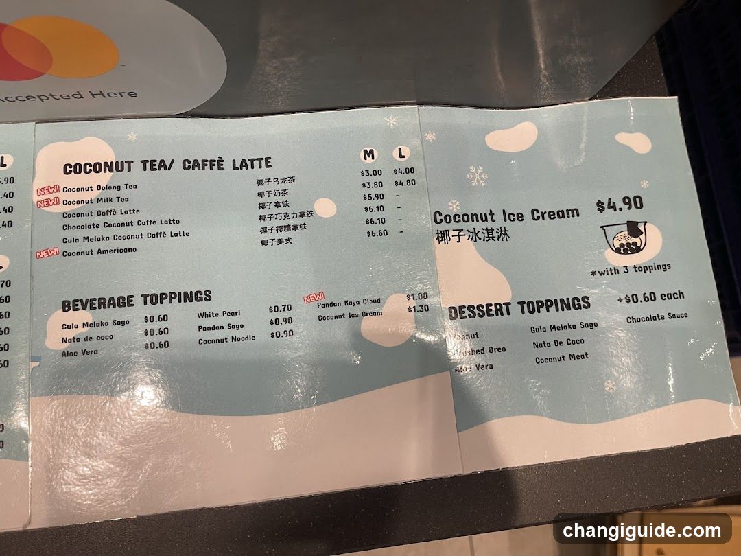 A printed menu featuring coconut tea, coffee lattes, beverage toppings, ice cream, and dessert options with prices in USD.