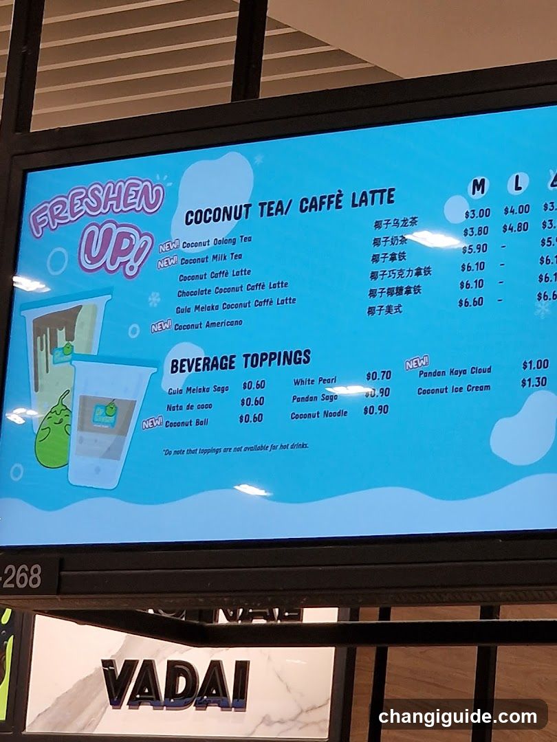 A digital menu board displaying coconut tea and café latte options with prices, including new items like Coconut Oolong Tea and Guai MeiKeo Coconut Caffe Latte.