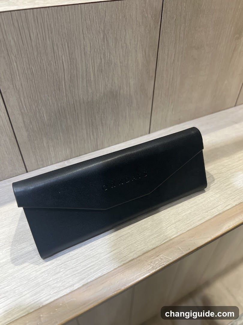 Black Eyeglass Case on Wooden Shelf