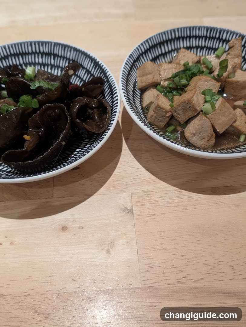 Two bowls of food on a wooden table