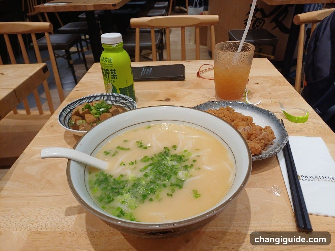 Dining Table with Noodles and Side Dishes