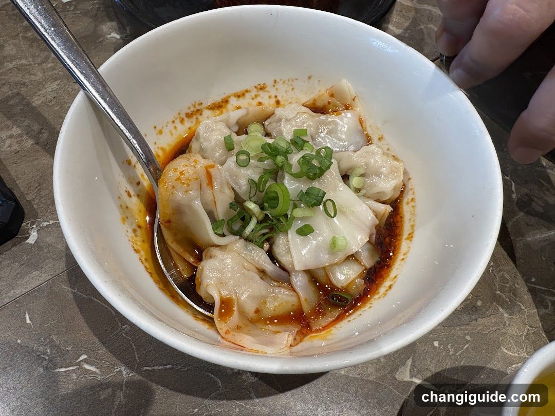 Bowl of Dumplings with Chili Oil and Scallions