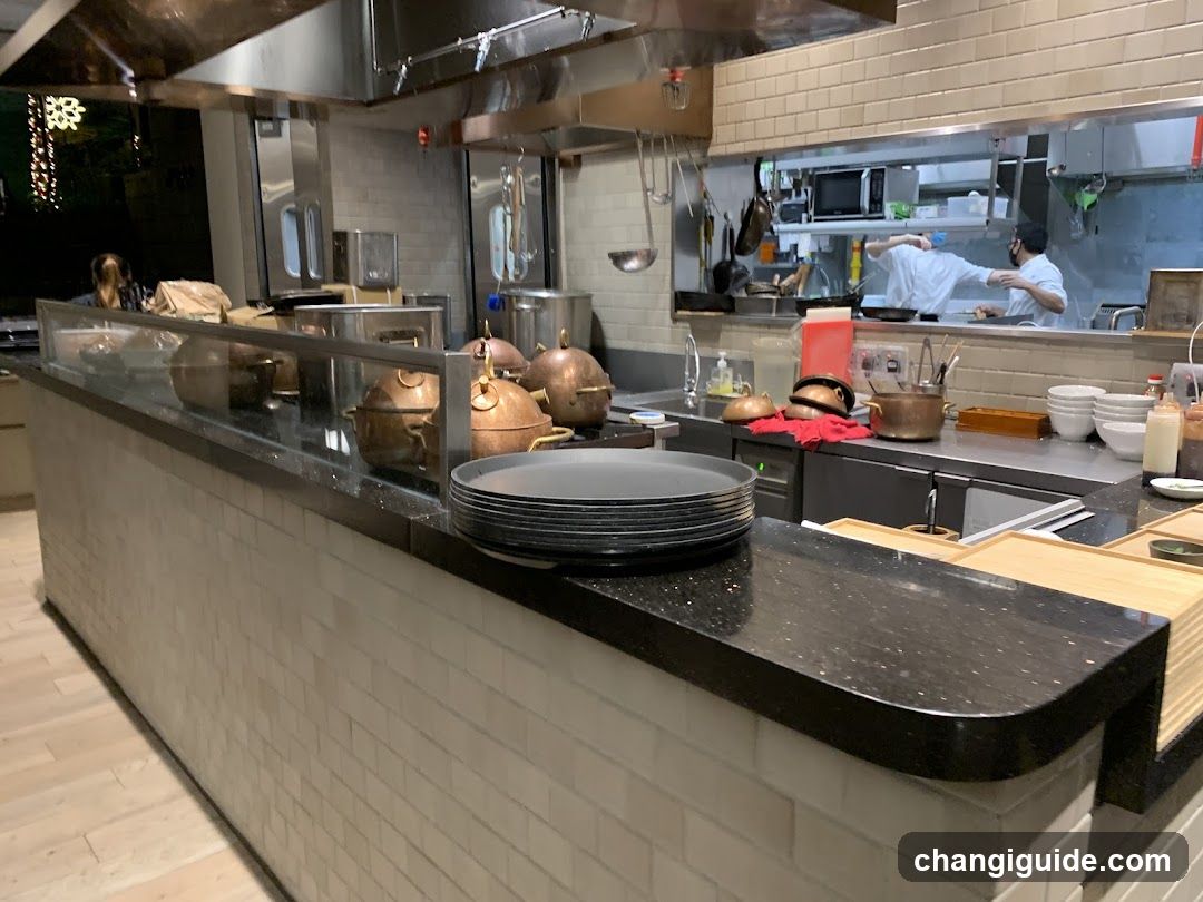 Kitchen Interior with Copper Pots and Staff