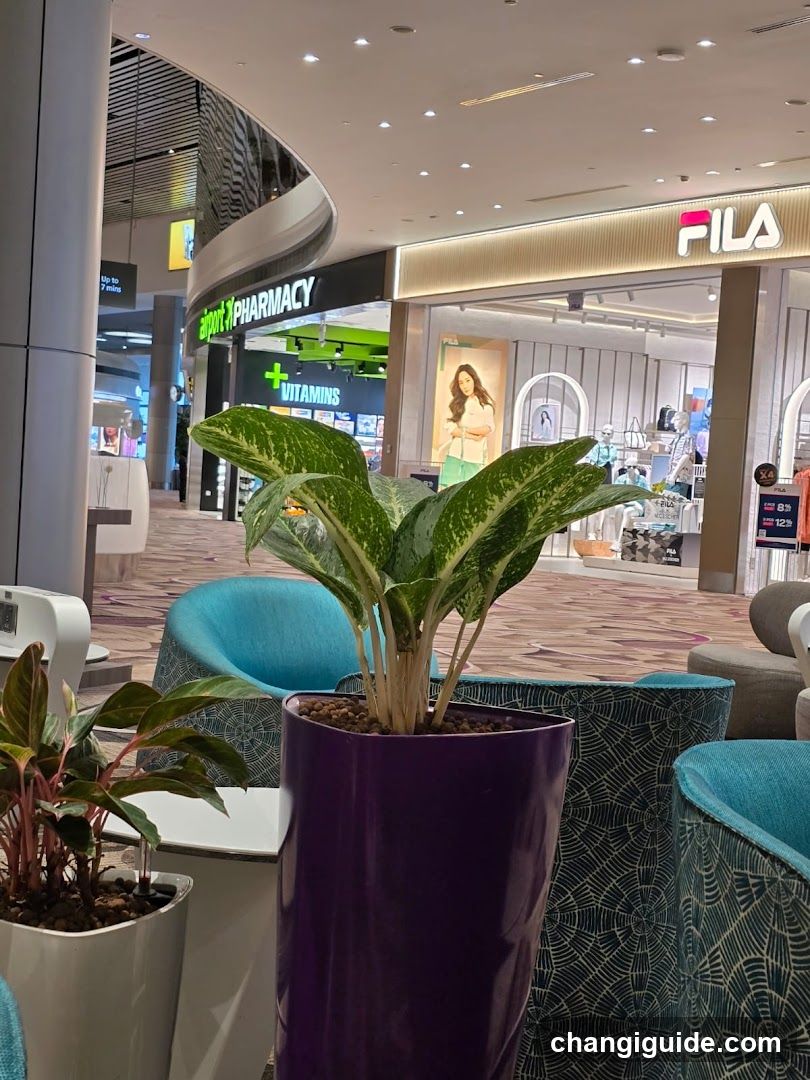 Shopping Mall Interior with Plants and Storefronts