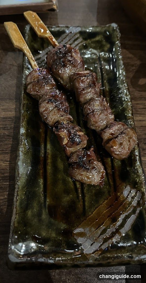 Grilled Meat Skewers on Ceramic Plate