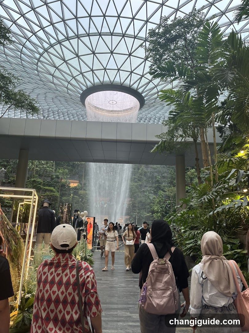Indoor Waterfall Scene with Visitors