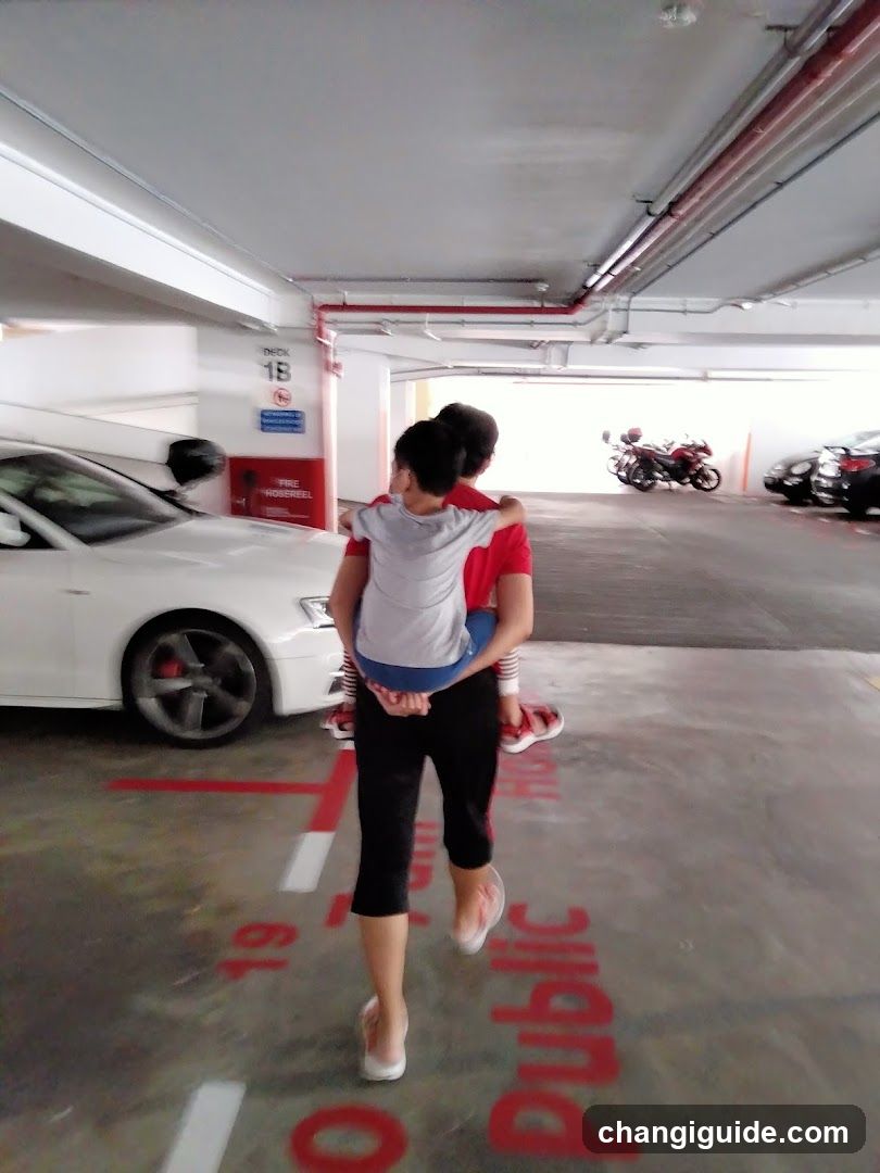 Couple carrying child in parking garage