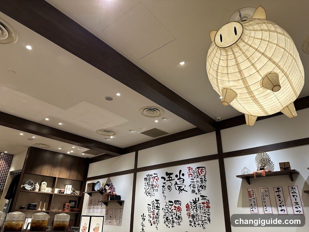 Interior of a Japanese-style shop with decorative lanterns and calligraphy walls.