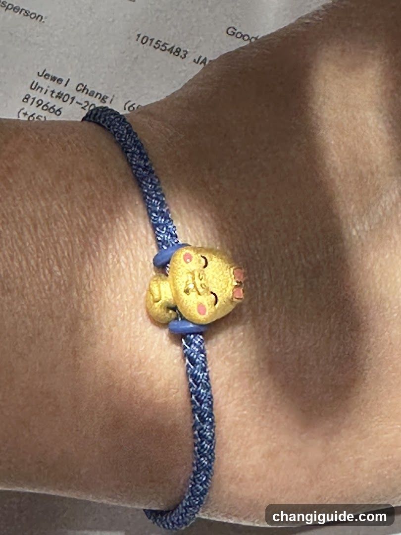 Blue braided bracelet with yellow character charm