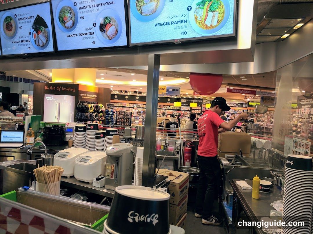 Food stall interior with menu boards above