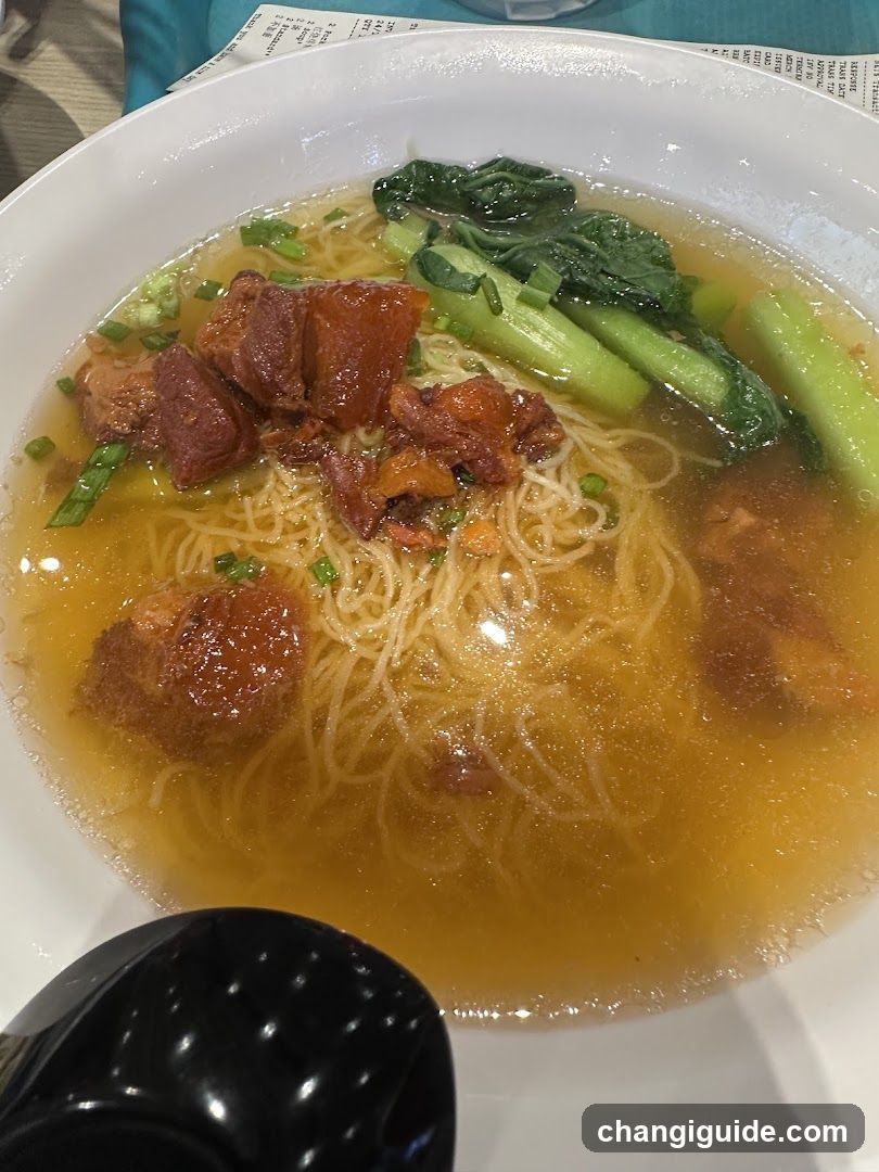 Bowl of Noodle Soup with Meat and Greens