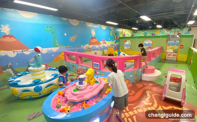 Indoor Play Area with Kids Playing in Sand Pits