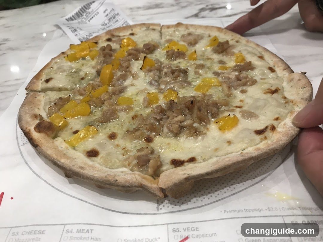 Pizza with yellow peppers and sausage