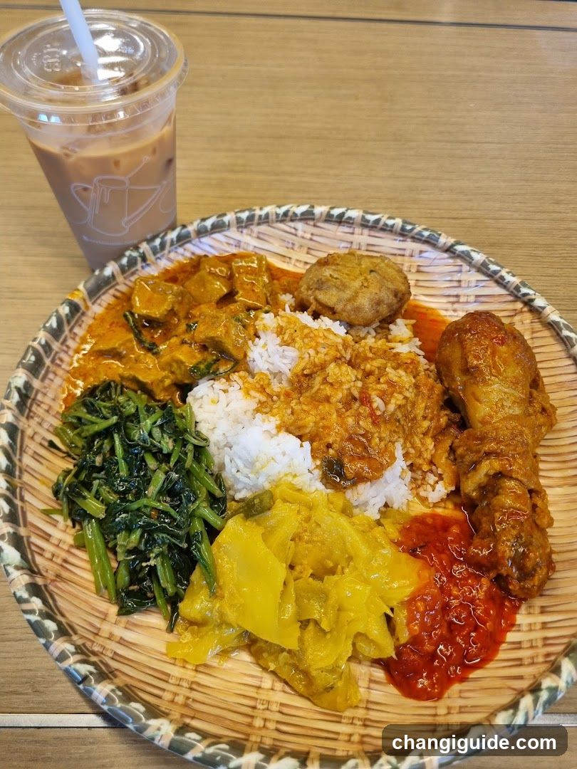 Nasi Lemak Plate with Side Dishes and Iced Coffee
