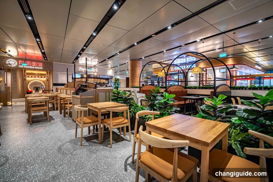Food Court Interior with Wooden Seating and Greenery