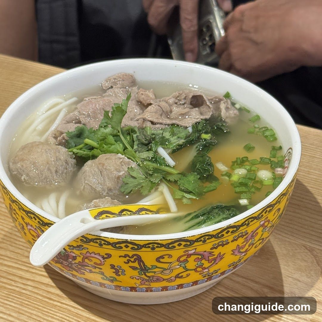 Bowl of Noodle Soup with Meatballs and Greens