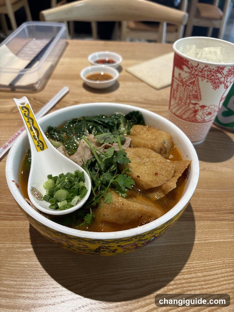 Bowl of Noodle Soup with Greens and Tofu Skin