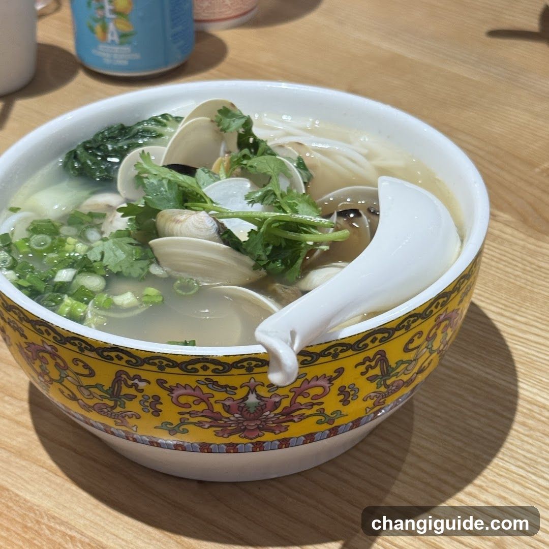 Bowl of Clam Soup with Greens and Scallions