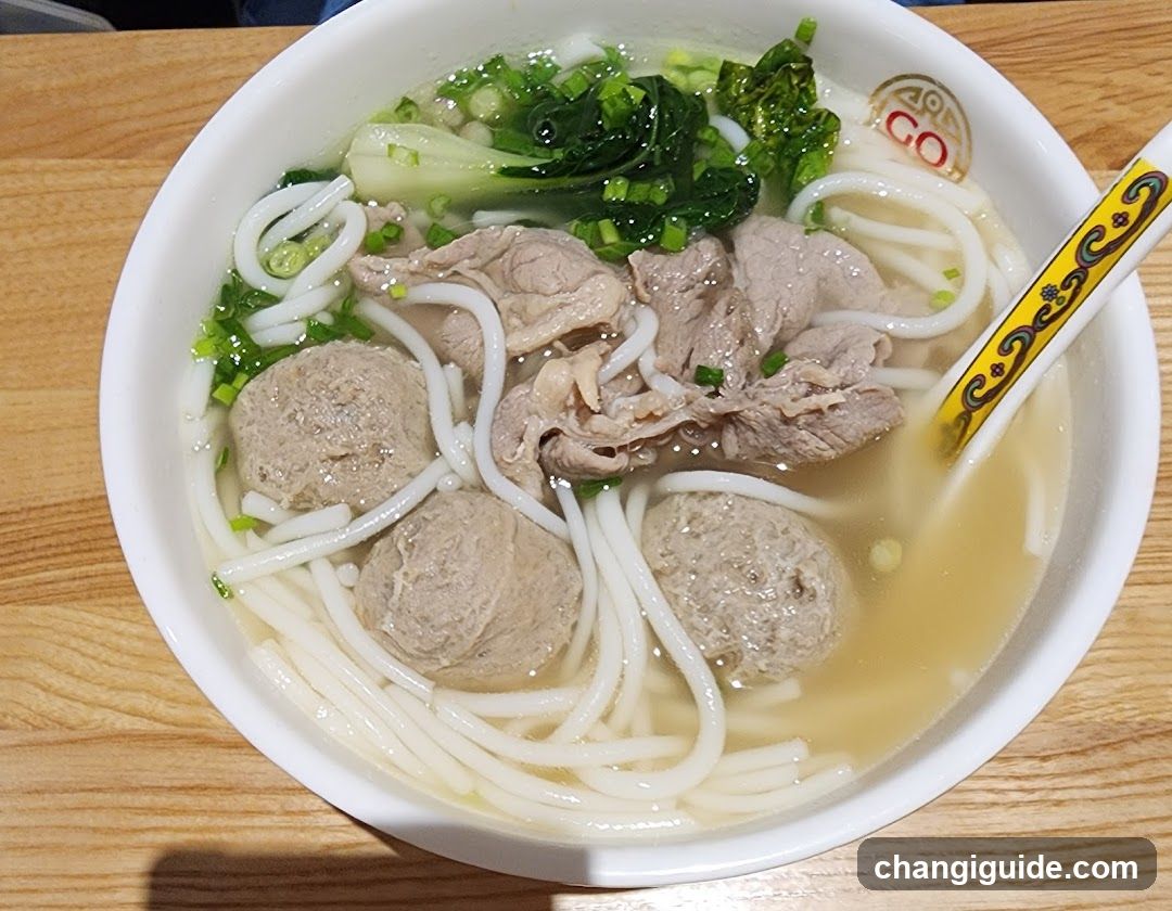 Bowl of Noodle Soup with Meatballs and Greens