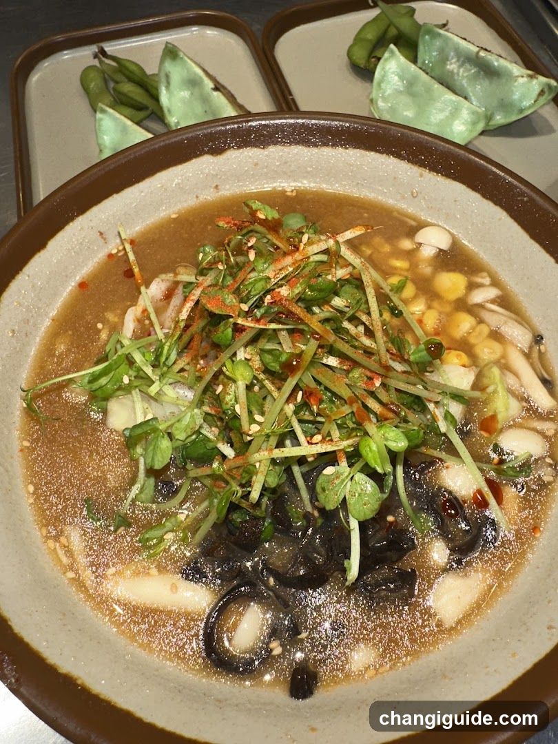 Bowl of Soup with Edamame and Greens