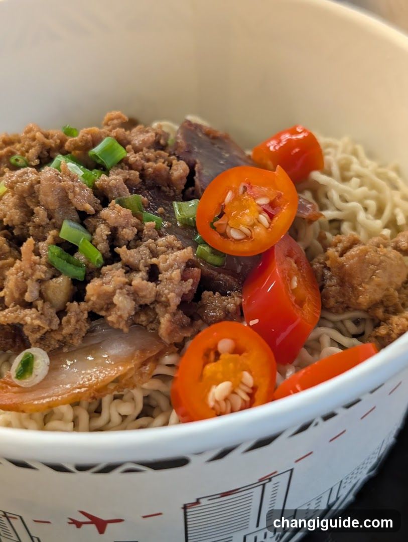 Spicy Noodle Bowl with Minced Meat and Chili Peppers