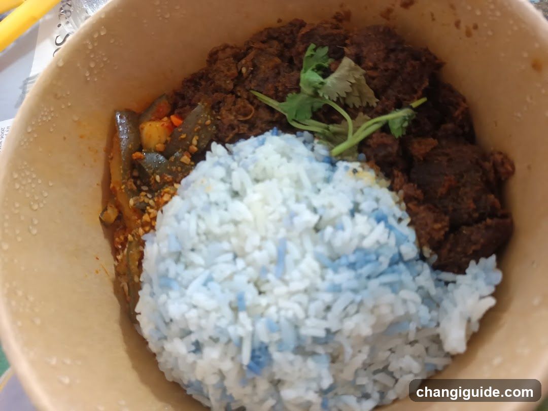 Bowl of Blue Rice with Meat and Curry