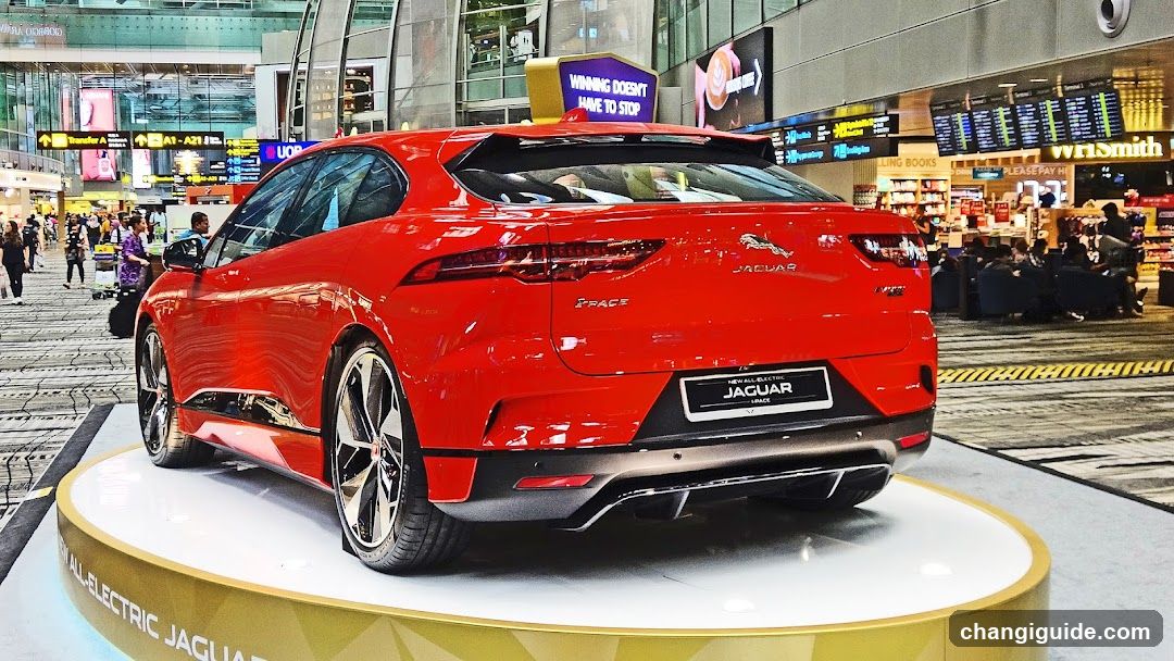 Red Jaguar I-PACE on display at airport terminal