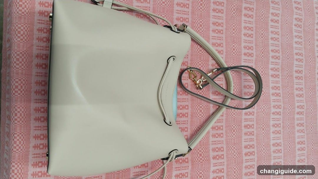 White Handbag on Patterned Fabric