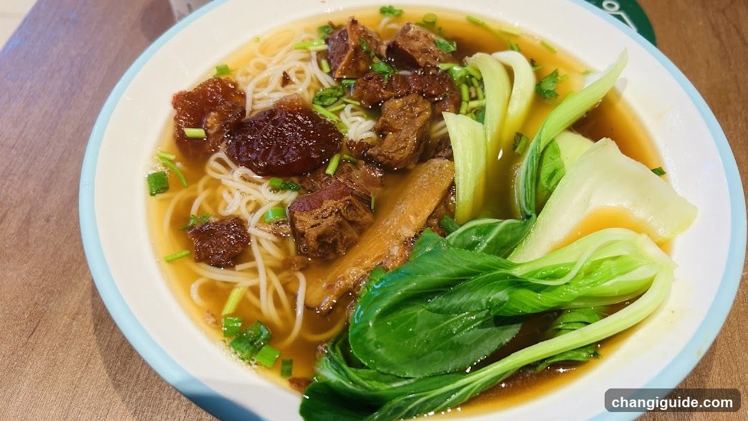 Bowl of Noodle Soup with Meat and Greens