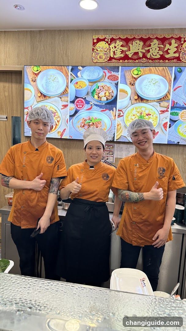 Chefs in Orange Uniforms Giving Thumbs Up